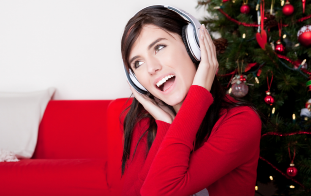 listening to music by Christmas tree